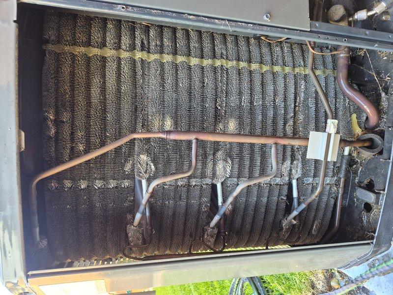 Completed Silver Comfort Plan clean and check on single air conditioning system. Performed comprehensive inspection of outdoor condenser unit, including examination of evaporator coil which showed significant dust and debris accumulation between fins. Documented equipment information and captured condition of copper refrigerant lines, connections, and heat exchanger components. Unit operational upon completion of maintenance service.
