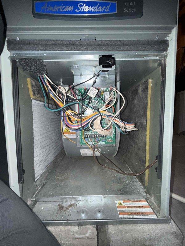 Completed annual tune-up maintenance on American Standard Gold Series air conditioning system. Performed comprehensive inspection of electrical components including capacitor, contactor, control boards, and all wire connections; verified proper operation of all system controls and safety devices. Documented system condition with interior component photography showing clean electrical compartment and properly functioning equipment.