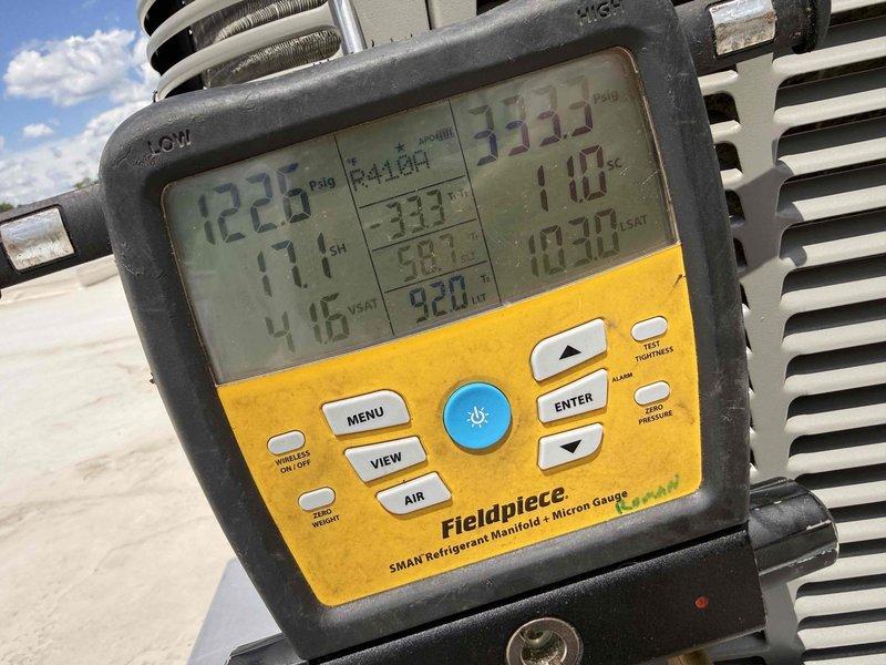 Responded to commercial tenant complaint of air conditioning system not operational. Accessed rooftop HVAC equipment and performed diagnostic testing using digital refrigerant manifold gauge. Verified system pressures, superheat, and subcooling readings on R410A unit. System found operating within normal parameters during inspection, with all mechanical components functioning properly.