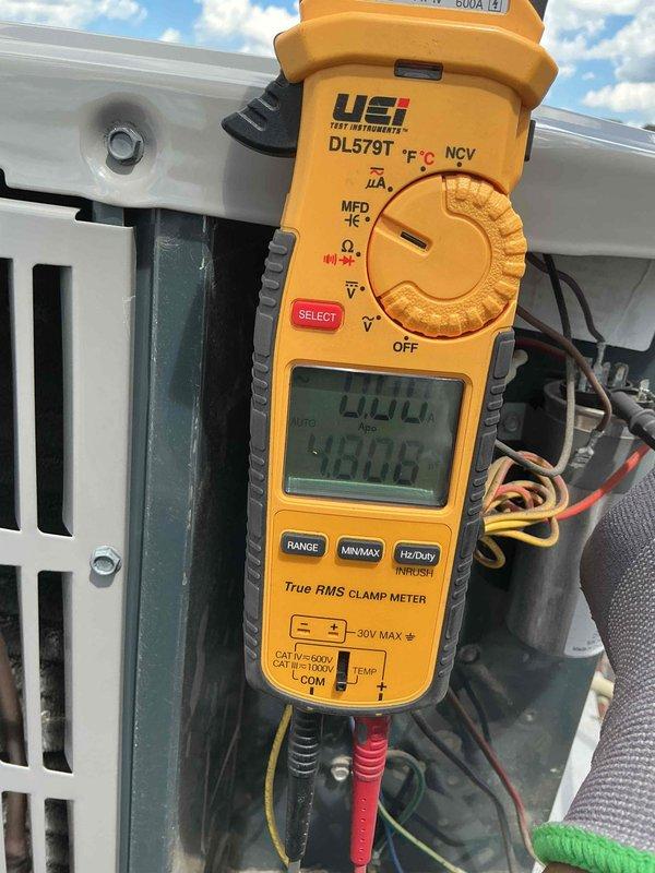 Completed air conditioning clean and check maintenance per the Comfort Plan agreement. Performed comprehensive system inspection of rooftop package unit, recording electrical readings showing 400V supply voltage and 48.06A operating amperage, which are within normal parameters. Cleaned condenser coil, checked refrigerant lines and electrical connections, and verified proper system operation.