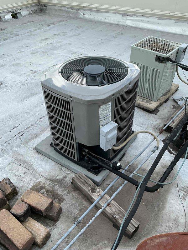 Completed air conditioning clean and check maintenance per the Comfort Plan agreement. Performed comprehensive system inspection of rooftop package unit, recording electrical readings showing 400V supply voltage and 48.06A operating amperage, which are within normal parameters. Cleaned condenser coil, checked refrigerant lines and electrical connections, and verified proper system operation.