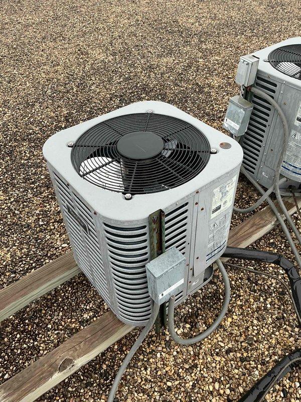 Identified noncondensables in the R-410A refrigerant system during diagnostic testing with manifold gauges. Recovered existing refrigerant charge and performed nitrogen purge throughout the system to remove contaminants. Removed and cleaned metering piston, then performed gravity-assisted nitrogen blow-through of refrigerant lines from rooftop condenser unit down to air handler. Reinstalled piston and installed new filter drier on 3/8" liquid line at air handler. Completed pressure test to verify system integrity, evacuated system to proper vacuum levels, and recharged with fresh R-410A refrigerant to manufacturer specifications. Verified all operating parameters and system performance upon completion.