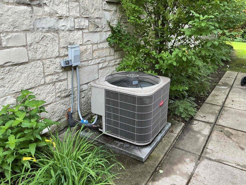 Completed Comfort Plan clean and check maintenance on Bryant air conditioning system. Performed comprehensive inspection of outdoor condensing unit, verified proper operation of all components, and checked refrigerant lines and electrical connections. System operating within normal parameters with temperature readings confirming adequate cooling performance at 45.8°F. Unit maintained in good condition with clear access and proper drainage on concrete pad.