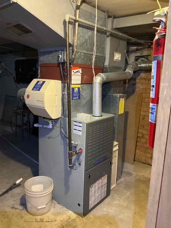 Completed comprehensive tune-up and maintenance on residential HVAC system including furnace and air conditioning components. Inspected White-Rodgers programmable thermostat for proper operation, verified temperature settings and control functions, and confirmed system cycling correctly between heating and cooling modes. Performed standard preventive maintenance procedures on furnace unit, inspected humidifier operation, checked all ductwork connections, and documented equipment condition with photographs for service records.