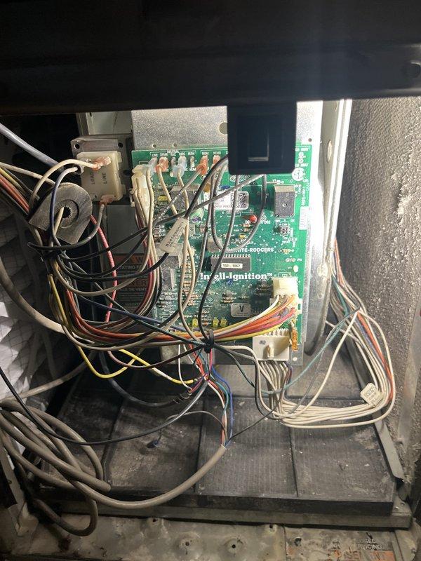 Completed HVAC system estimate for replacement of existing equipment. Inspected furnace and air handler assembly, documenting current control board wiring configuration and connections. Evaluated 35-year-old electric filter air handler for replacement with standard filter box configuration using 20x25x5 filter dimensions. Photographed existing system components including circuit board, relay connections, and overall equipment installation in utility room to support replacement recommendations.