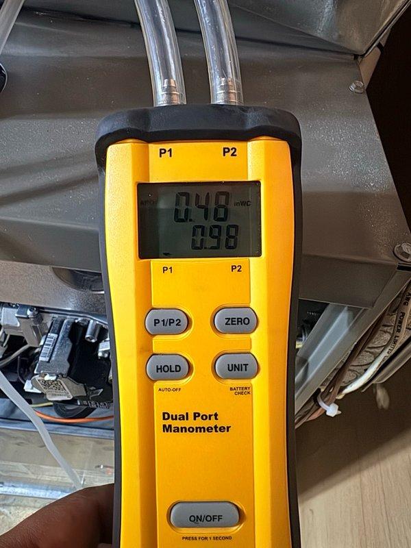 Completed annual air conditioning clean and check maintenance per comfort plan agreement. Performed system pressure diagnostics using dual port manometer, recording static pressure readings of 0.48 and 0.98 inches water column to verify proper airflow and system performance. Inspected and confirmed clean air filter in good condition with proper installation. All equipment found operating within normal parameters with no deficiencies noted.