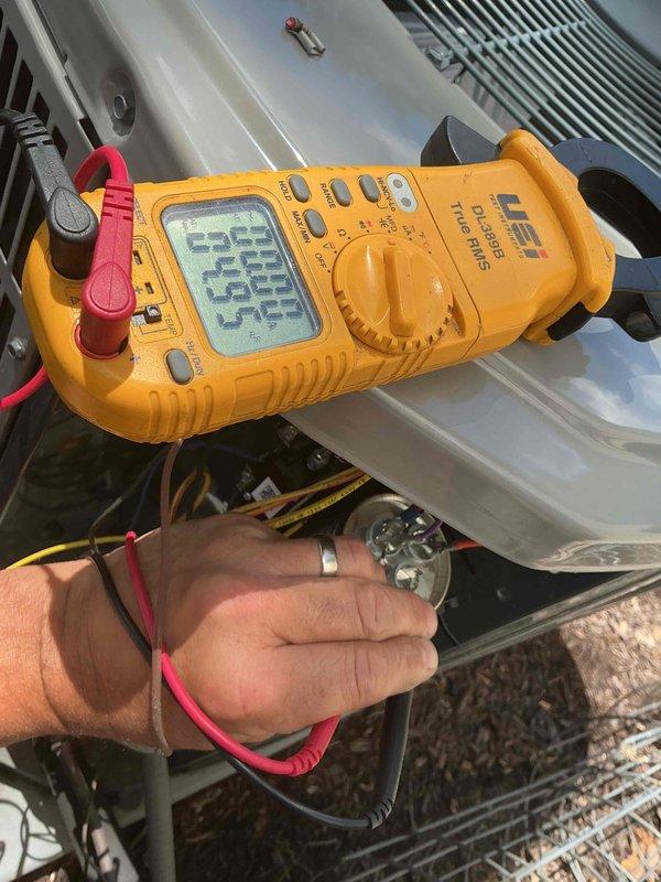 Completed comprehensive tune-up and maintenance on single HVAC system. Performed diagnostic testing and measurements including temperature differential readings and electrical voltage checks across system components, with multimeter readings confirming proper 24-volt control circuit operation. Inspected and assessed bypass humidifier damper per reported concerns regarding functionality and positioning, documenting system conditions with detailed photographs of equipment and measurement readings for service records.