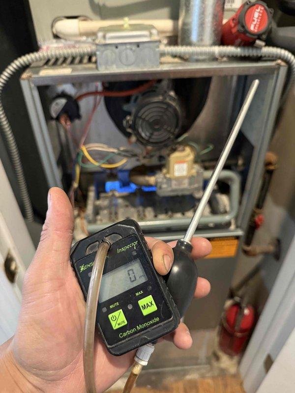 Completed comprehensive clean and check maintenance on furnace and air conditioning system per comfort plan agreement. Performed carbon monoxide safety testing with digital analyzer, confirming zero CO detection and safe operation of heating system. Inspected all internal furnace components including blower motor, gas valve assembly, electrical connections, and control systems. Addressed significant dust and debris accumulation on blower assembly and air handler components through thorough cleaning to restore proper airflow and system efficiency. Verified all mechanical and electrical systems operating within normal parameters for both heating and cooling equipment.