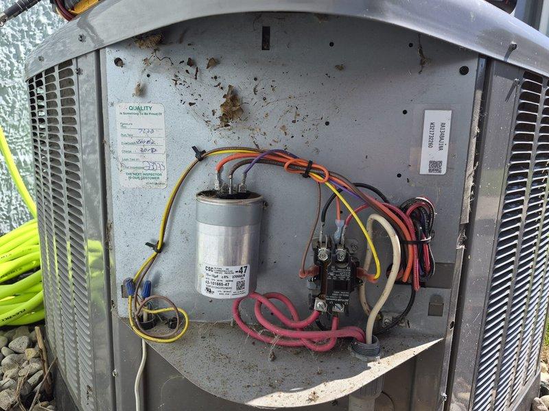 Performed comprehensive clean and check maintenance on air conditioning system per comfort plan agreement. Inspected and photographed condensing unit components including capacitor, contactor, and electrical connections; noted interior compartment required cleaning due to dirt and debris accumulation. Checked air filter condition in service area and verified proper system operation upon completion.