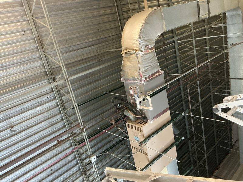 Completed commercial HVAC system replacement including air conditioning unit and evaporator coil installation in mechanical room. New equipment was properly positioned, secured, and connected with insulated ductwork, electrical conduit, and refrigerant lines. System was tested and confirmed operational upon completion.