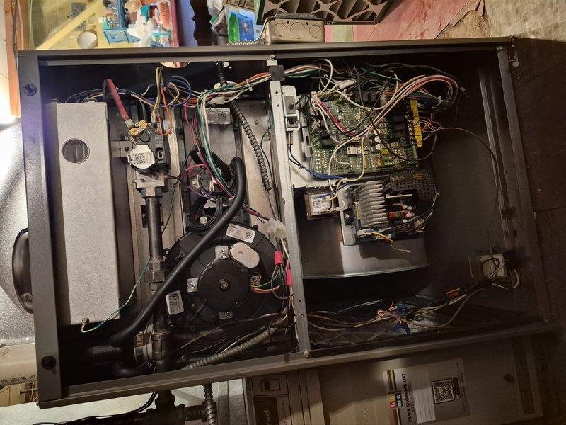 Performed comprehensive clean and check maintenance on air conditioning system per Comfort Plan agreement. Conducted electrical diagnostics using digital multimeter to verify system voltage and amperage readings, confirming proper electrical supply at 28.8 volts to control circuits. Inspected indoor air handler unit with panel removed, examining blower motor assembly, control boards, wiring connections, and safety circuits for proper operation and signs of wear. All electrical connections tested and found secure, circuit boards functioning within normal parameters, and blower motor operating smoothly without unusual noise or vibration. System cleaned, tested, and returned to normal operation.