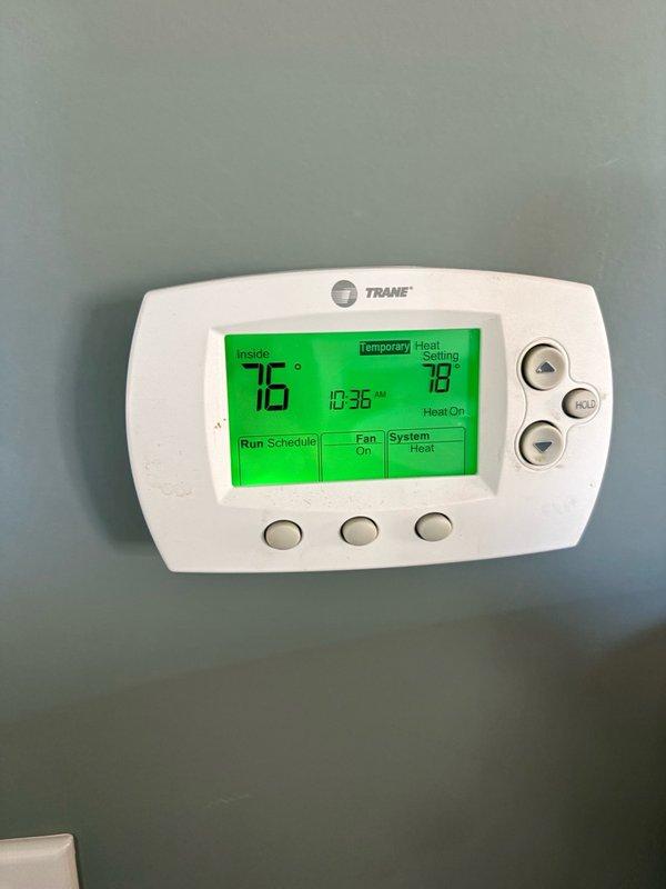 # Replace Heat Exchanger For Attic Furnace

Replaced failed heat exchanger on residential Trane furnace system located in attic space. Ordered replacement heat exchanger component for delivery and installation. System verified operational with thermostat displaying proper heating function at time of service call, set to 78°F with current indoor temperature reading of 76°F at 10:36 AM. Furnace installation includes proper PVC venting configuration for intake and exhaust, gas supply lines with shutoff valves, and insulated flexible ductwork distribution system. Unit positioned on concrete surface with appropriate clearances maintained for service access and safety compliance.