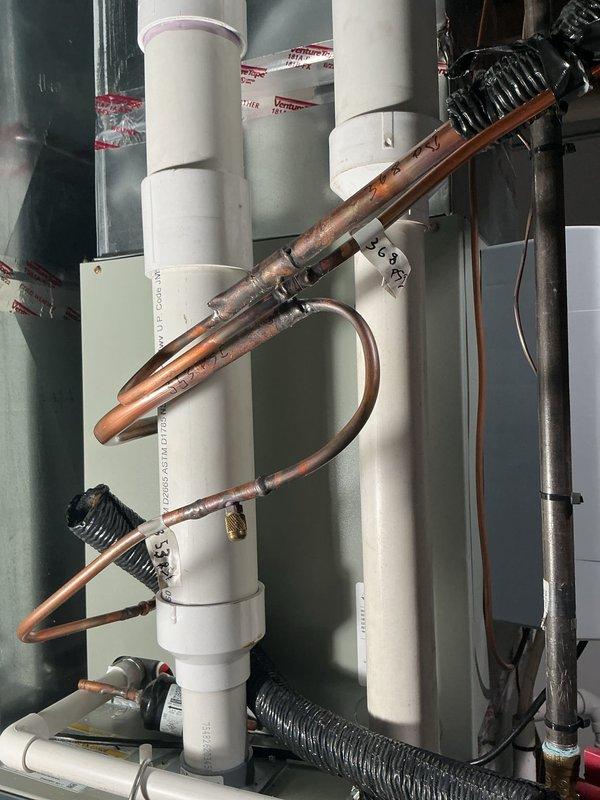 Isolated the condenser unit from the evaporator coil and refrigerant lineset to perform nitrogen pressure testing at 450 psi on all three components separately. Documented pressure readings with photographs showing the system configuration, including the copper refrigerant lines with visible oxidation and the indoor coil assembly with associated PVC drainage piping. Full payment was collected upon completion of the diagnostic pressure test.