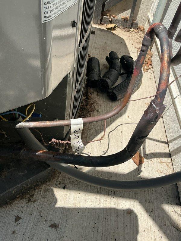 Isolated the condenser unit from the evaporator coil and refrigerant lineset to perform nitrogen pressure testing at 450 psi on all three components separately. Documented pressure readings with photographs showing the system configuration, including the copper refrigerant lines with visible oxidation and the indoor coil assembly with associated PVC drainage piping. Full payment was collected upon completion of the diagnostic pressure test.