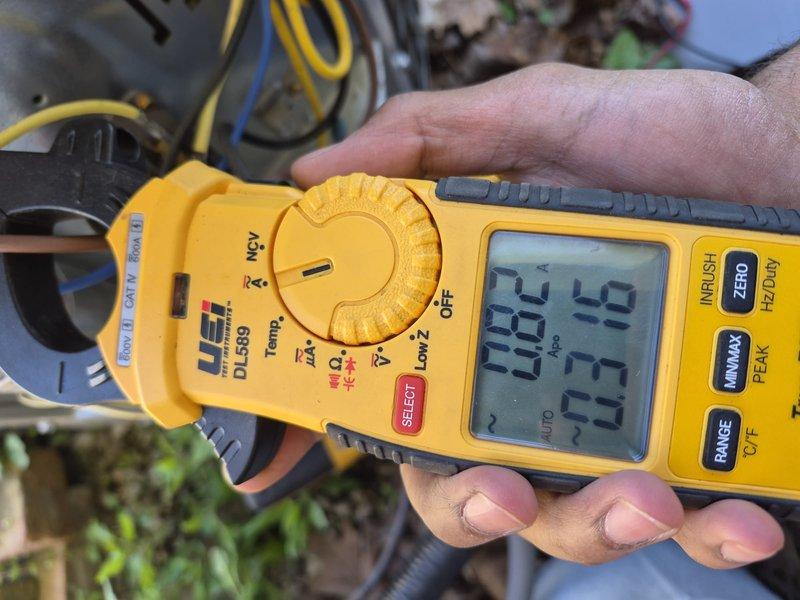 Responded to callback for recurring system failure following circuit board replacement from previous week. Upon arrival, confirmed air conditioning and heating system were both non-operational. Performed diagnostic testing using clamp meter to measure electrical current and voltage at outdoor condensing unit. Readings indicated abnormal amperage draws and potential electrical supply issues affecting both AC and furnace operation. Documented equipment conditions and electrical measurements with photos showing 26.9 and 39.63 amp readings at condenser unit. Further troubleshooting required to identify root cause of repeated system failures beyond previously replaced control board.