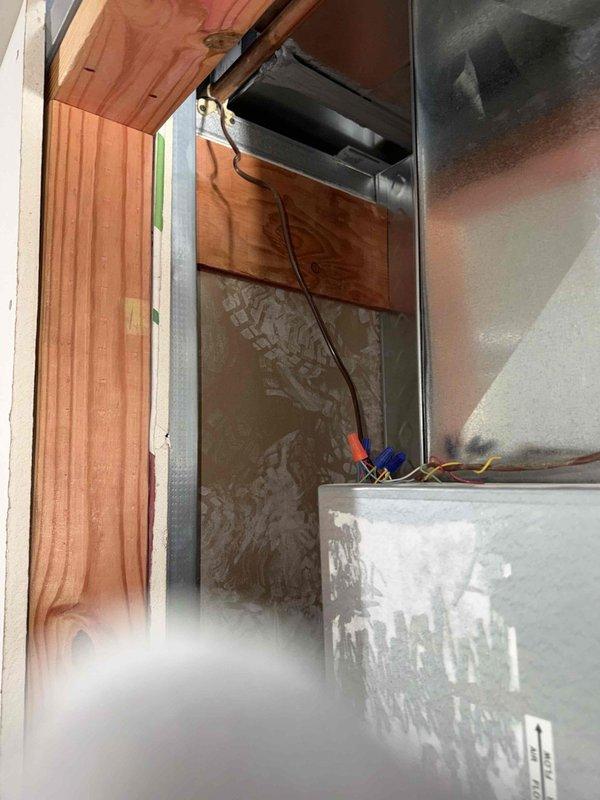 Installed new thermostat wire run from heat pump air handler to relocated wall-mounted thermostat position at 60 inches above finished floor height. Routed low-voltage wiring through unfinished framing to new thermostat location as specified by general contractor, terminated connections at both heat pump unit and thermostat, and verified proper wire identification at all terminal points.