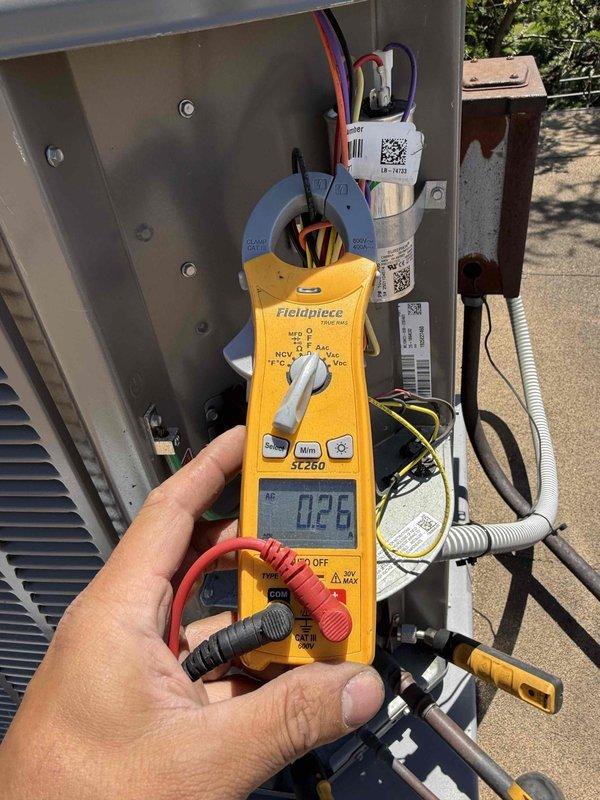 Completed comprehensive clean and check maintenance service on single HVAC system per comfort plan agreement. Performed electrical diagnostics using clamp meter to verify compressor amperage draw and system performance, recording readings of 35.73 amps and confirming proper operation within manufacturer specifications. Inspected all electrical connections, capacitor integrity, and control wiring throughout air handler and condensing unit, documenting system condition with photos for service records.