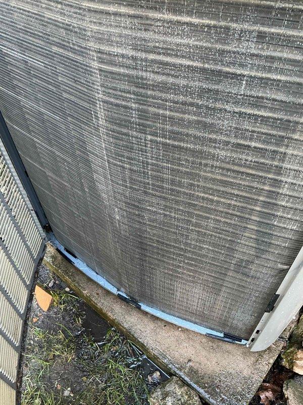 Completed preventive maintenance clean and check on residential air conditioning system per comfort plan agreement. Accessed indoor air handler through exterior panel, inspected evaporator coil and internal components. Serviced outdoor condenser unit which exhibited significant mineral deposits and environmental buildup on fin coil surfaces, performed thorough coil cleaning to restore heat transfer efficiency and system performance.