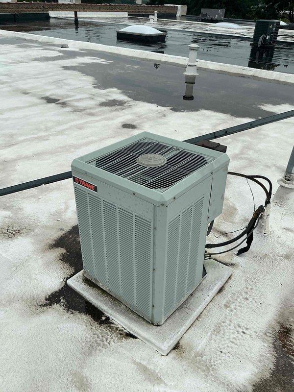 Completed Comfort Plan clean and check maintenance on single rooftop HVAC system. Performed comprehensive inspection of condensing unit including electrical components, capacitor, control board, and all wire connections. Verified proper operation of all system components, cleaned unit as needed, and confirmed system is functioning within normal parameters. Note: Customer indicated only one AC system present despite service order listing two units - discrepancy flagged for office review.