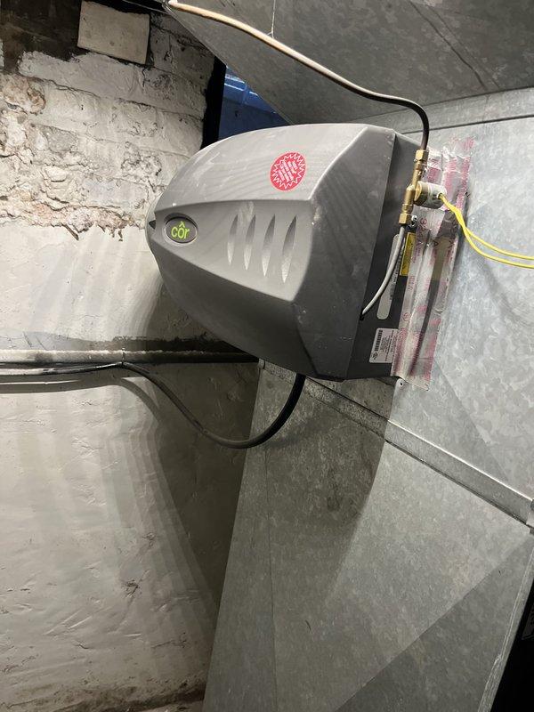 Performed estimate consultation for furnace replacement on 20-year-old American Standard heating system. Previous contractor identified hairline fracture in heat exchanger requiring unit replacement. Documented existing equipment configuration including furnace unit, ductwork connections, and humidifier system with photographs of data plates and current installation for replacement specifications.
