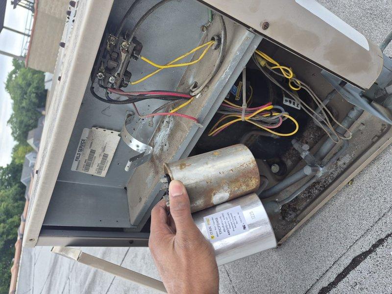 Responded to service call for outdoor HVAC unit experiencing operational issues. Upon inspection, identified a heavily corroded and failed 45/5 dual run capacitor that had sustained significant rust damage from prolonged exposure to outdoor elements and moisture. Removed the deteriorated capacitor from the electrical compartment and installed a new replacement capacitor to restore proper system functionality. Verified all electrical connections were secure, tested unit operation, and confirmed system returned to normal performance parameters.