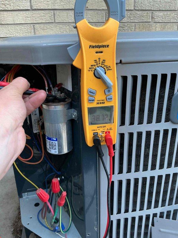 # HVAC Maintenance - Comfort Plan Clean and Check 1 System

Completed spring preventive maintenance inspection on residential split system consisting of American Standard furnace and outdoor condensing unit per comfort plan agreement. Performed comprehensive electrical diagnostics on outdoor unit using clamp meter to verify proper amperage draw and component operation. Inspected and tested capacitor, contactor, and all electrical connections within condensing unit, ensuring secure wire terminations and proper voltage readings. Verified outdoor unit airflow through condenser coil and checked refrigerant line insulation condition. Inspected indoor furnace unit in basement mechanical room, confirming proper labeling and general equipment condition. System operating within normal parameters with no immediate repairs required at time of service.