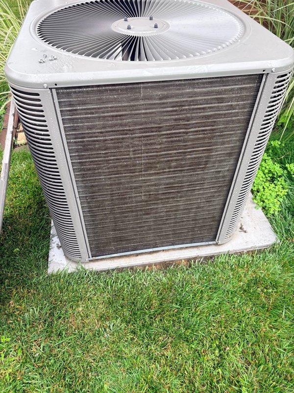 Completed spring clean and check maintenance on single-system air conditioning unit per comfort plan agreement. Inspected outdoor condenser unit with visible dirt and debris accumulation on coil surfaces, examined indoor air handler blower motor assembly with squirrel cage fan, verified electrical connections and component operation. All system components functioning properly with routine maintenance performed according to manufacturer specifications.