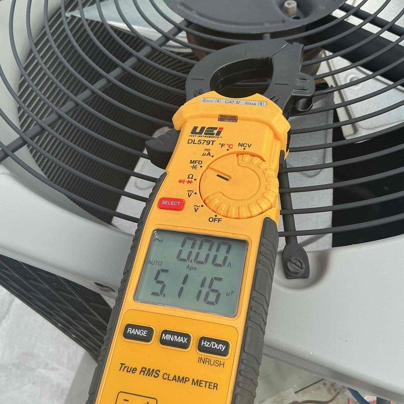 Completed comprehensive clean and check maintenance service on single air conditioning system per comfort plan agreement. Performed system diagnostics using digital multimeter, verified temperature differentials at 57.16°F, and inspected air filter condition. Filter showed moderate dust accumulation in pleats and was evaluated for airflow restriction. Conducted electrical measurements with clamp meter on outdoor condensing unit, confirming zero amp draw at time of testing. Inspected condenser fan grille and motor assembly, verified proper operation of outdoor unit components. System operational upon completion of preventive maintenance service.