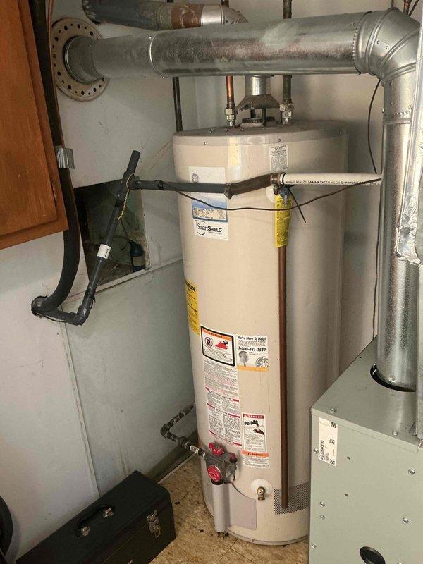 Responded to return visit for ongoing basement water leak with suspected condensate line backup. Upon arrival, inspected HVAC system and associated plumbing components in mechanical room. Verified proper pitch and drainage of PVC condensate line using level to ensure gravity flow. Examined water heater, ductwork connections, and surrounding plumbing infrastructure for potential leak sources. Documented equipment conditions and plumbing configuration with photos. All equipment information recorded for service records.