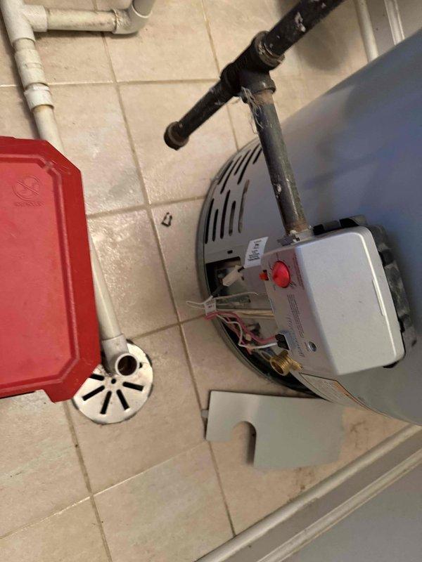 # Tanked Water Heater Leak Assessment

Responded to service call for leaking water heater at residential property. Upon arrival, confirmed water supply to tank had been shut off by occupant, with no active leaking present at time of inspection. Conducted thorough visual examination of water heater unit and surrounding plumbing connections. Inspected copper supply lines, flexible connectors, temperature and pressure relief valve, drain valve, and tank integrity for signs of moisture, corrosion, or failure points. Documented condition of unit and piping configuration with photographic evidence. Identified source of reported leak and provided assessment of water heater condition. Advised on necessary repairs or replacement options based on findings.