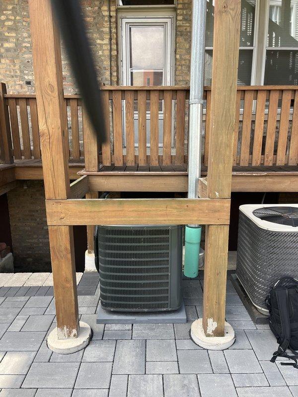 Conducted comprehensive site assessment for complete air conditioning system replacement at residential property. Evaluated existing outdoor condenser units, including aging cylindrical unit positioned beneath elevated deck structure on paver patio and secondary unit on rooftop platform. Documented current equipment configuration, installation locations, and spatial constraints for replacement planning. Assessed deck clearances, accessibility for future service, and structural considerations for proper equipment placement. Photographed existing HVAC equipment conditions, mounting surfaces, and surrounding infrastructure to develop accurate replacement specifications and equipment recommendations for customer consideration of both AC and potential furnace system upgrades.