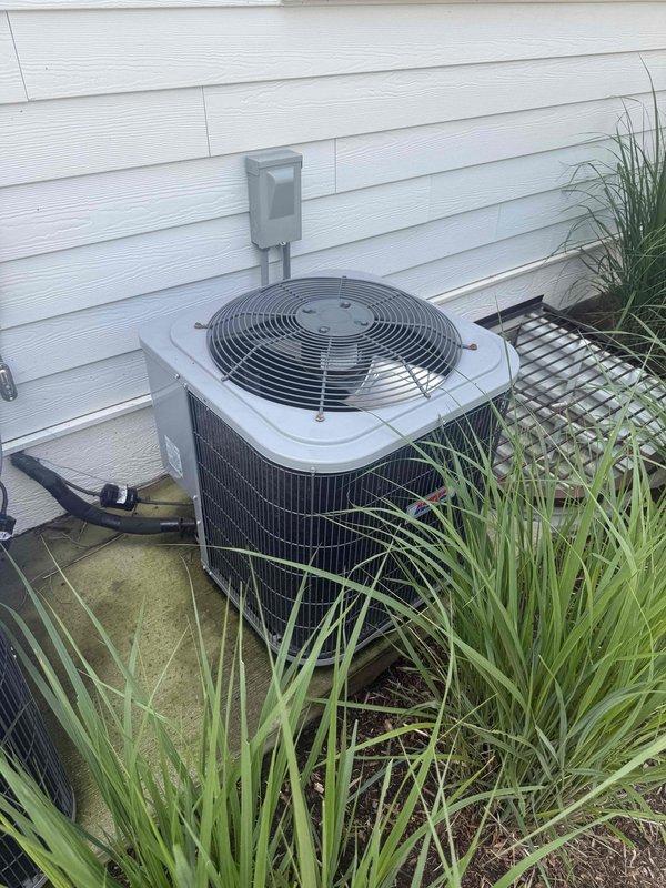 Responded to no cooling complaint on downstairs AC unit. Upon arrival, verified thermostat settings and confirmed unit was running but not cooling effectively. Performed system diagnostics including temperature measurements at indoor unit showing supply air temperature of 37°F, indicating inadequate cooling performance. Inspected outdoor condenser unit and found equipment operational with fan running and compressor engaged. Observed condenser pad showing signs of moisture accumulation and algae growth, indicating potential drainage concerns. Checked refrigerant charge levels, airflow across evaporator coil, and electrical connections at disconnect box. Documented equipment information and captured diagnostic readings for service records.
