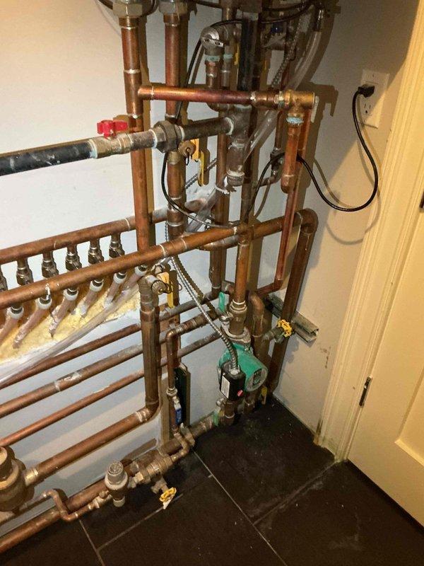 Responded to no heat call for radiant floor heating system. Upon arrival, inspected tankless water heater and hydronic heating manifold system with multiple zone circuits. Found circulator pump operational and all zone valves functioning properly. Verified tankless water heater firing correctly with cover removed for internal inspection. Checked copper distribution piping, manifold connections, and all shut-off valves throughout the system. Confirmed proper water flow through heat exchanger and adequate supply temperature. Tested electrical connections and circulator pump operation. System restored to full operational status with all zones heating properly.