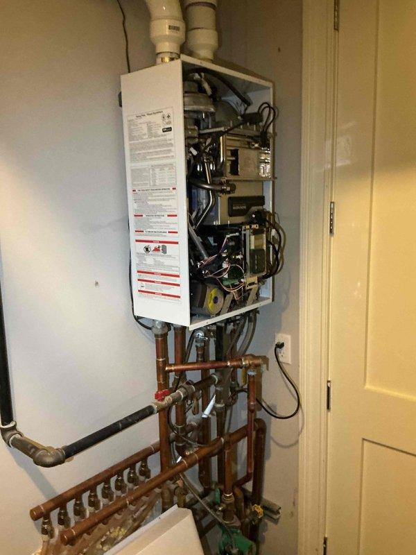 Responded to no heat call for radiant floor heating system. Upon arrival, inspected tankless water heater and hydronic heating manifold system with multiple zone circuits. Found circulator pump operational and all zone valves functioning properly. Verified tankless water heater firing correctly with cover removed for internal inspection. Checked copper distribution piping, manifold connections, and all shut-off valves throughout the system. Confirmed proper water flow through heat exchanger and adequate supply temperature. Tested electrical connections and circulator pump operation. System restored to full operational status with all zones heating properly.