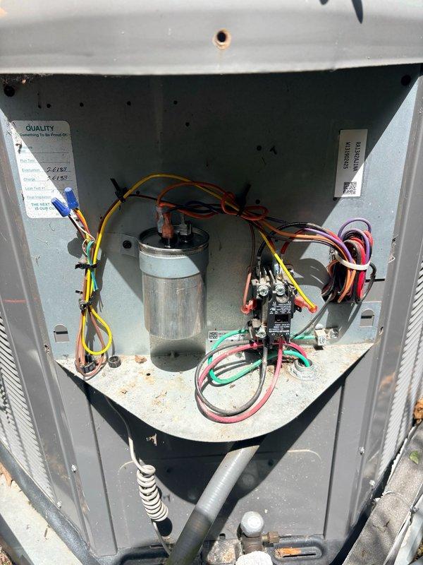 Responded to no cooling complaint on second floor air conditioning system. Upon arrival, verified thermostat was properly set to cooling mode at 68°F with system actively running and displaying "Cool On" status. Performed diagnostic inspection of outdoor condensing unit, removing access panel to examine internal components including capacitor, electrical connections, and control wiring. All electrical connections were secure with no signs of damage or loose terminals. Capacitor appeared in good physical condition with proper wire terminations on HERM, FAN, and COM terminals. Verified system operation and airflow at thermostat location showing 74°F ambient temperature with unit actively cooling.