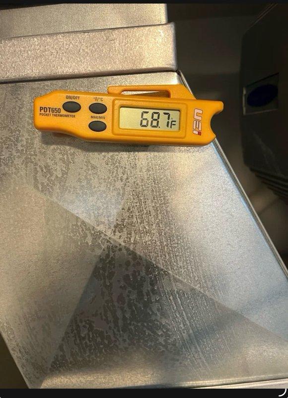 Responded to callback for floor cooling unit not cooling properly after previous day's refrigerant charging service. Upon inspection, discovered significant frost accumulation on evaporator coil surface, indicating potential overcharge condition or restricted airflow. Verified supply air temperature reading of 68.7°F, which is insufficient for proper cooling operation. Consulted manufacturer's operating performance specifications and pressure charts to determine correct system parameters. Identified refrigerant overcharge as primary issue causing improper system operation and frost formation. Recovered excess refrigerant and adjusted charge to manufacturer specifications based on operating pressures and ambient conditions. Verified proper airflow across evaporator coil and confirmed system returned to normal operating temperatures and pressures. Unit cycling properly with adequate cooling capacity restored.
