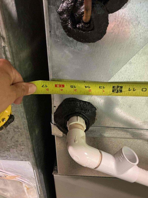 Responded to no cooling complaint on residential air conditioning system. Upon inspection, performed diagnostic evaluation of HVAC system including air handler and condensate drain assembly. Documented equipment specifications and current system condition with measurements and photographic evidence. Based on previous furnace inspection findings from November that revealed cracked heat exchanger, discussed comprehensive system replacement options for both heating and cooling equipment due to age and condition of matched system components.