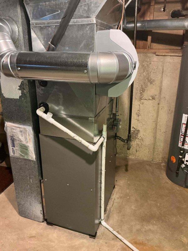 Responded to no cooling complaint on residential air conditioning system. Upon inspection, performed diagnostic evaluation of HVAC system including air handler and condensate drain assembly. Documented equipment specifications and current system condition with measurements and photographic evidence. Based on previous furnace inspection findings from November that revealed cracked heat exchanger, discussed comprehensive system replacement options for both heating and cooling equipment due to age and condition of matched system components.