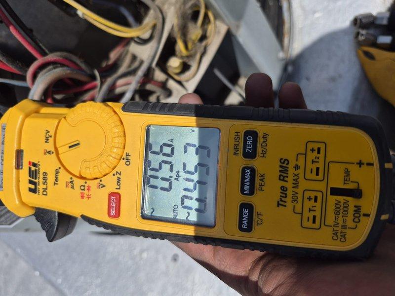 # HVAC Service Report

Responded to new customer air conditioning system experiencing significant frost and ice buildup on evaporator coil and ductwork components. Upon inspection, discovered extensive crystalline ice formation covering metal surfaces throughout the air handling unit, indicating restricted airflow or refrigerant system issues. Performed diagnostic testing using clamp meter to measure electrical parameters, recording amperage draw of 19.2A and voltage reading of 233V to assess compressor and system performance. Ice accumulation pattern suggested potential low refrigerant charge, restricted airflow from dirty filter or coil, or malfunctioning expansion valve causing improper refrigerant metering. System required defrost cycle completion before further diagnostics could be performed. Documented conditions with photographic evidence for service records and customer reference.
