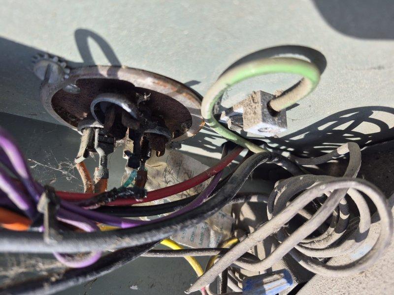 Responded to service call for reported compressor noise and electrical issues causing interior lights to flicker. Upon inspection of rooftop unit, discovered severely damaged electrical connections with extensive corrosion, heat damage, and compromised wiring throughout the compressor circuit. Found capacitor with significant burn marks and melted insulation on multiple conductors, indicating electrical arcing and overload conditions. Documented hazardous wiring conditions with evidence of weather exposure, deteriorated wire insulation, and failed electrical components that posed immediate safety concerns and explained cause of reported symptoms.