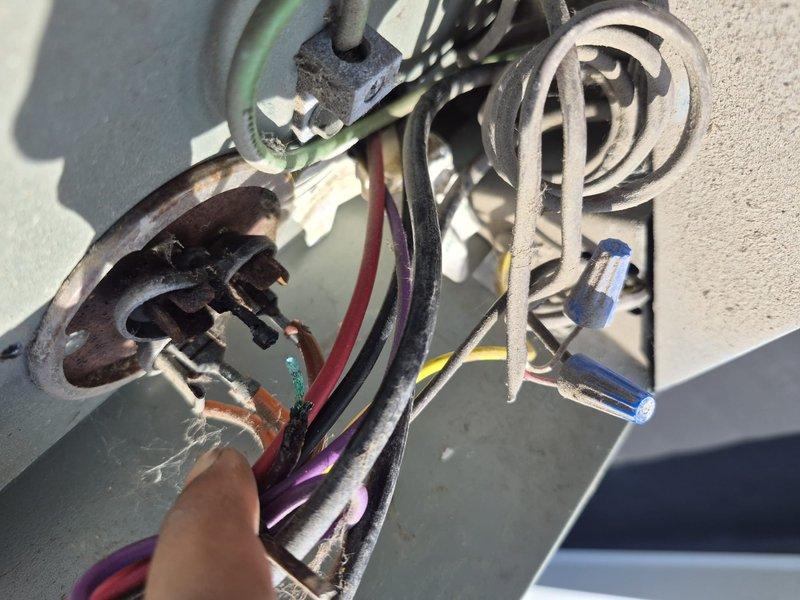 Responded to service call for reported compressor noise and electrical issues causing interior lights to flicker. Upon inspection of rooftop unit, discovered severely damaged electrical connections with extensive corrosion, heat damage, and compromised wiring throughout the compressor circuit. Found capacitor with significant burn marks and melted insulation on multiple conductors, indicating electrical arcing and overload conditions. Documented hazardous wiring conditions with evidence of weather exposure, deteriorated wire insulation, and failed electrical components that posed immediate safety concerns and explained cause of reported symptoms.