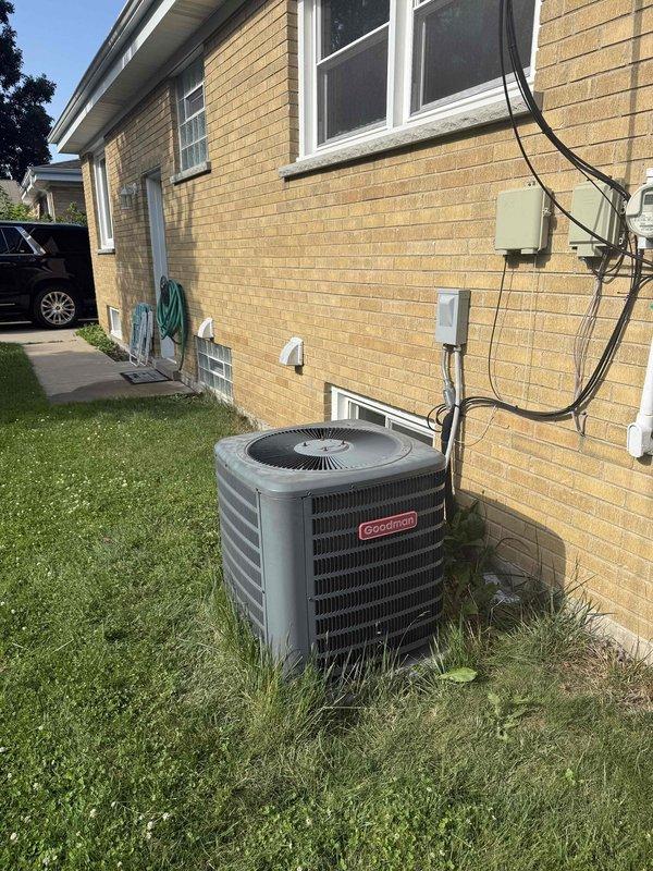Responded to no-cooling call at residential property with Goodman condensing unit. Upon arrival, performed diagnostic evaluation of system using clamp meter to measure electrical parameters. Tested amperage draw, verified power supply to outdoor unit, and inspected capacitor, contactor, and associated wiring connections. Documented equipment information and captured diagnostic readings showing 2.9 measurement on multimeter during troubleshooting process. Identified issue affecting tenant comfort and provided repair options to property owner.