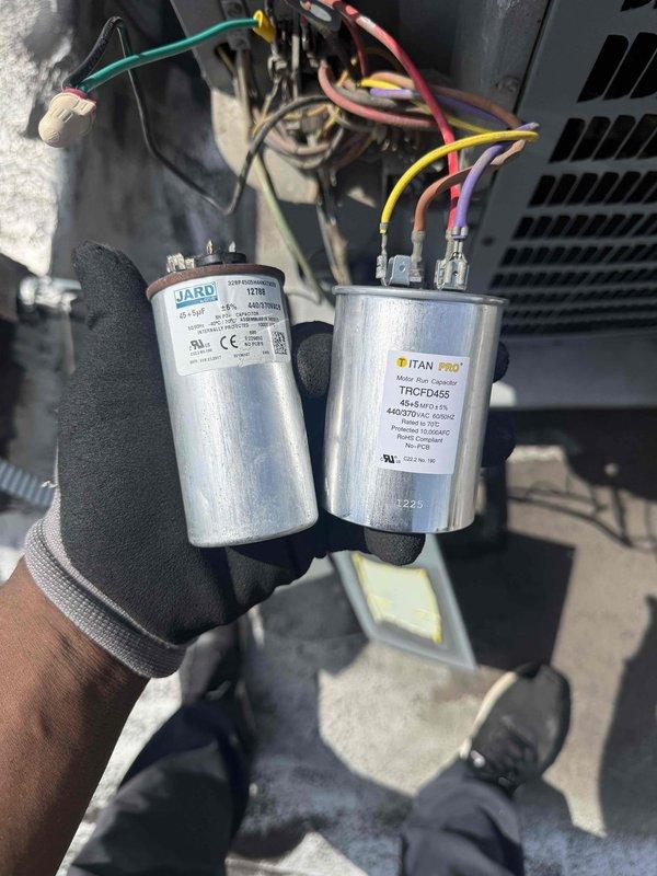 Replaced failed dual-run capacitor on rooftop air conditioning unit. Removed defective JARD capacitor and installed new TITAN PRO TRCFD455 rated at 440-370 VAC to restore proper starting torque and operational power to compressor and fan motors. Unit tested and verified operational upon completion.