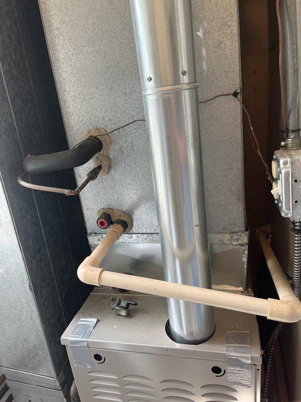 Conducted comprehensive assessment of existing residential HVAC system for replacement estimate. Customer requested evaluation due to advanced age of current equipment. Documented existing air handler unit, furnace, and associated ductwork configuration including vertical metallic duct runs, condensate drainage system with PVC piping, and gas line connections. Photographed complete system layout to support replacement recommendations and equipment sizing requirements.