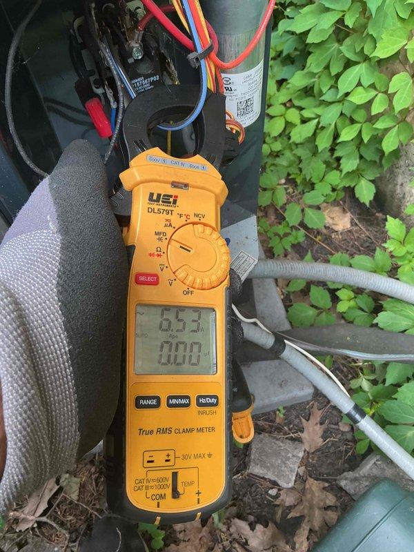 Completed spring preventive maintenance and clean and check service on residential air conditioning system per comfort plan agreement. Performed comprehensive inspection of outdoor condensing unit, measured and recorded electrical amperage readings at 65.3 amps indicating proper compressor operation, verified capacitor specifications and connections, and checked all electrical components for proper function. Noted vegetation growth around unit requiring future clearance to maintain adequate airflow and prevent potential service issues.