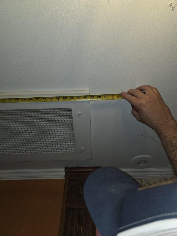 Completed on-site estimate for second floor Unico high-velocity air handler replacement. Performed detailed measurements of existing return air vent locations and clearances at ceiling level to assess system configuration and spatial requirements for new equipment installation. Documented existing HVAC infrastructure with photographic evidence to support replacement specifications and ensure proper sizing of new high-velocity system components.