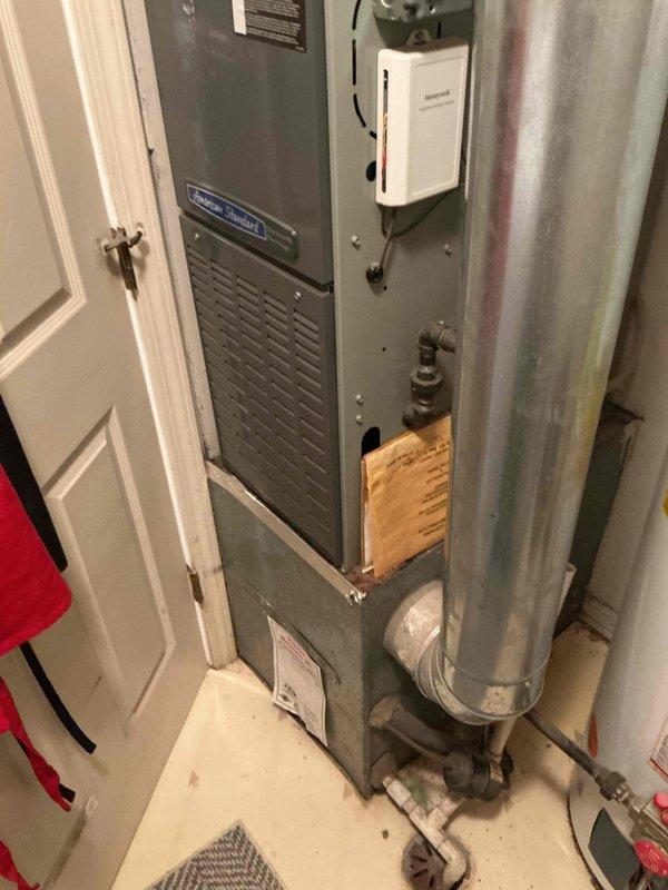 Completed preventative maintenance clean and check on residential single-system HVAC equipment per service comfort plan agreement. Performed comprehensive inspection and servicing of American Standard furnace unit located in interior utility closet, including filter evaluation, burner assembly inspection, and verification of all safety controls and operational components. Inspected gas line connections, condensate drainage system, and Honeywell control device for proper function. Proceeded to exterior condenser unit positioned against building foundation and performed thorough cleaning of coil surfaces, removed debris accumulation from surrounding protective cage and base area, verified fan motor operation and blade assembly condition, and confirmed refrigerant pressures within manufacturer specifications. All equipment tested and found operating within normal parameters with no immediate concerns identified. System returned to full operational status.