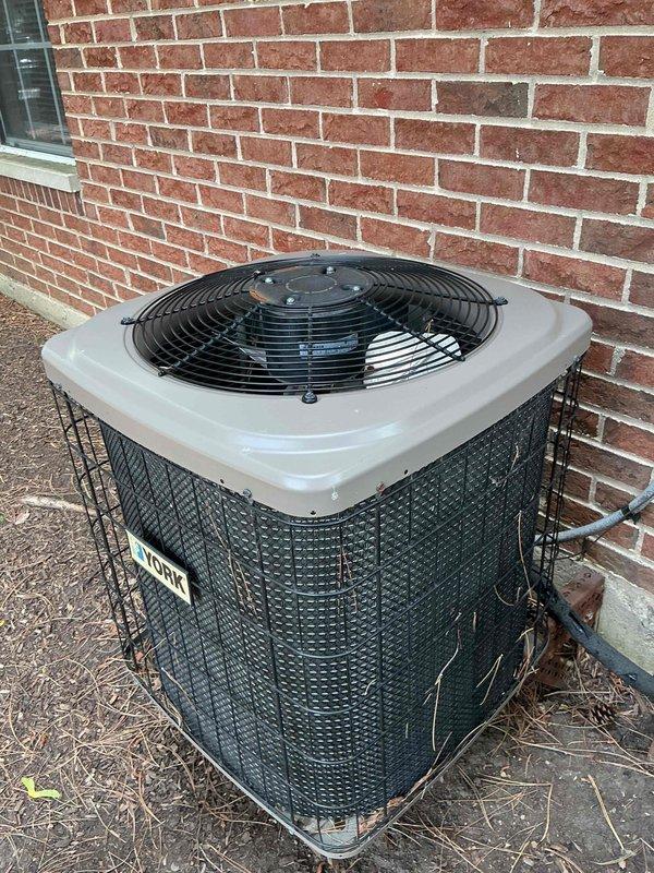 Completed preventative maintenance clean and check on residential single-system HVAC equipment per service comfort plan agreement. Performed comprehensive inspection and servicing of American Standard furnace unit located in interior utility closet, including filter evaluation, burner assembly inspection, and verification of all safety controls and operational components. Inspected gas line connections, condensate drainage system, and Honeywell control device for proper function. Proceeded to exterior condenser unit positioned against building foundation and performed thorough cleaning of coil surfaces, removed debris accumulation from surrounding protective cage and base area, verified fan motor operation and blade assembly condition, and confirmed refrigerant pressures within manufacturer specifications. All equipment tested and found operating within normal parameters with no immediate concerns identified. System returned to full operational status.