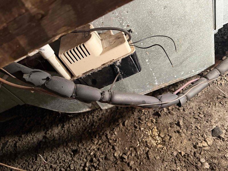 Responded to service call for air conditioning system with reported pump malfunction. Upon inspection, located condensate pump in crawl space beneath structure. Found pump experiencing operational failure, preventing proper drainage of condensate water from HVAC system. Tested pump functionality and confirmed mechanical failure. Assessed drainage line configuration and verified proper installation of insulated refrigerant lines in crawl space area. Documented equipment condition and crawl space environment. Discussed repair options and preventive maintenance recommendations with customer to restore full system operation.