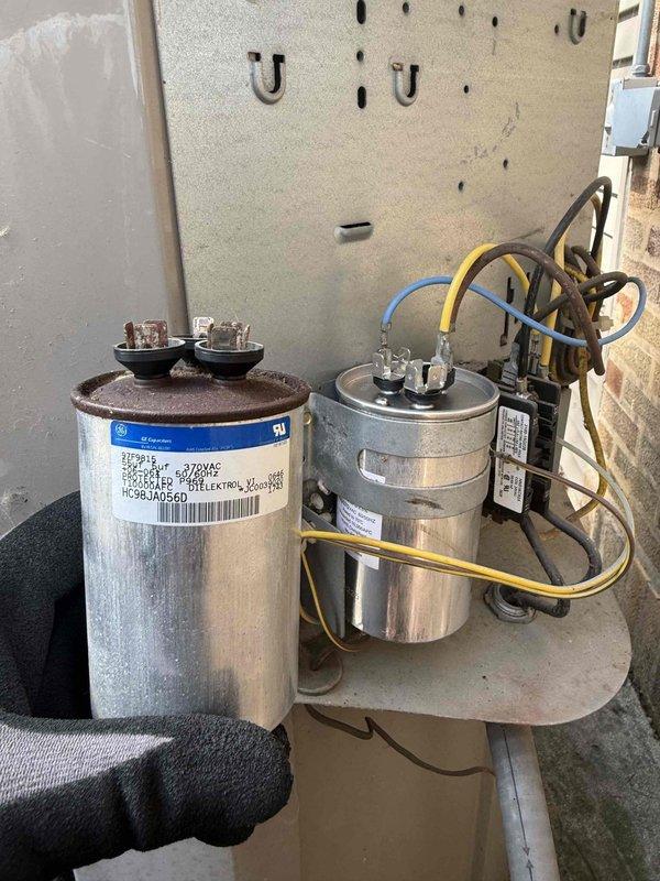 Responded to no cooling complaint on residential air conditioning system. Upon arrival, performed diagnostic inspection of outdoor condensing unit and indoor air handler. Visual inspection revealed failed dual-run capacitor with distended casing and compromised electrical connections. Evaporator coil exhibited heavy frost accumulation indicating restricted airflow or refrigerant system issue secondary to compressor failure to operate. Tested electrical components including contactor and verified proper voltage supply to unit. Documented system conditions with photographs showing capacitor failure and abnormal ice buildup on evaporator coil. Initial diagnosis confirmed compressor circuit failure preventing unit operation, though compressor itself requires additional testing to determine if failure is due to capacitor only or if compressor has sustained internal damage. Explained findings and recommended replacement of failed capacitor as first step, with additional compressor testing re